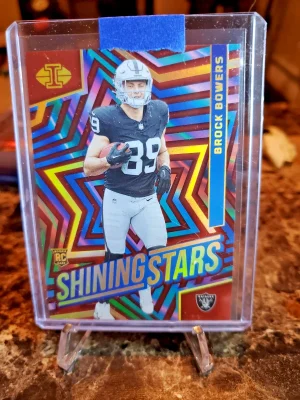 2024 Panini Illusions - Shining Stars Brock Bowers #7 Red /99 (RC)